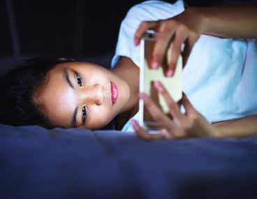 Woman using smartphone to illustrate blue light protection